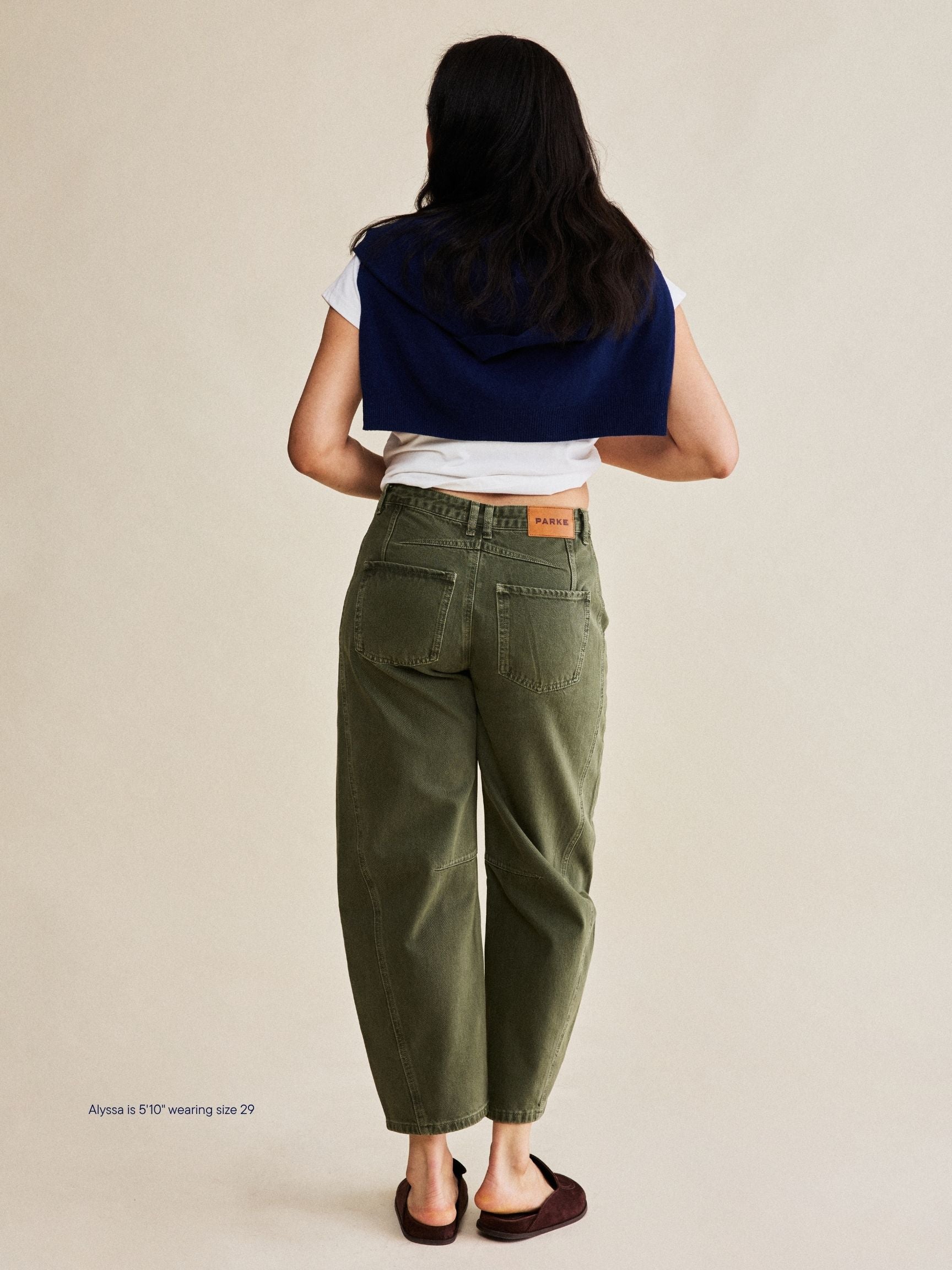 girl wearing horseshoe jeans -olive