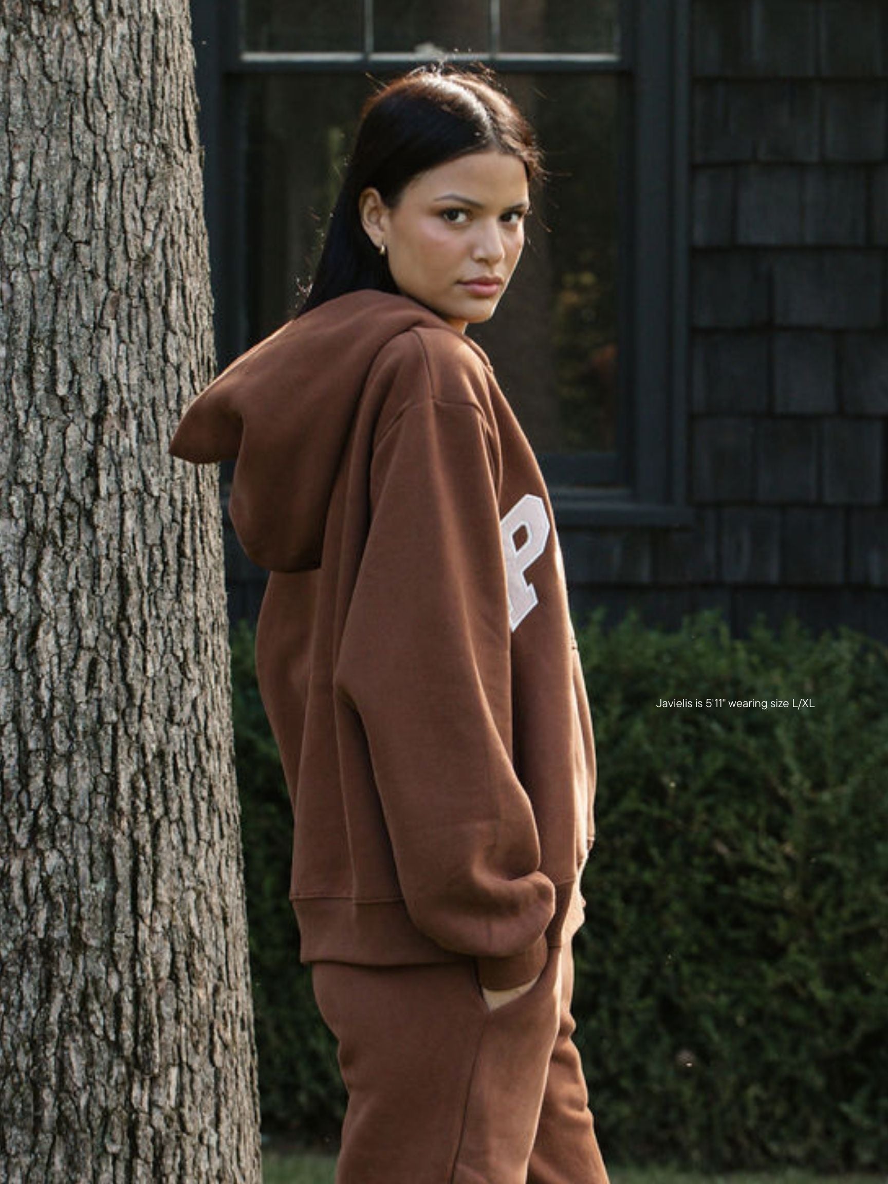 girl wearing varsity zip up hoodie -mocha + rose