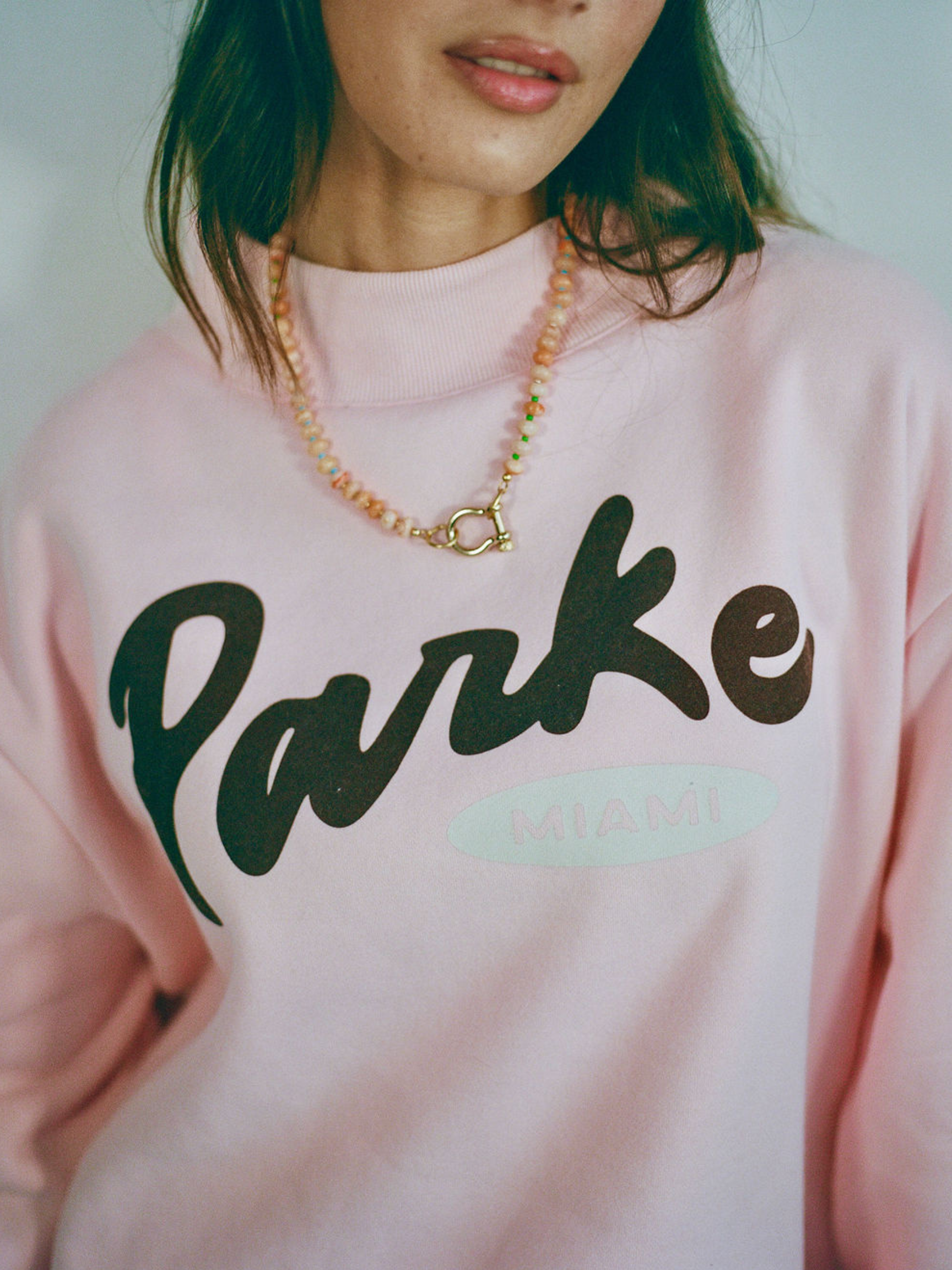 girl wearing spciy dan necklace flat lay -orange