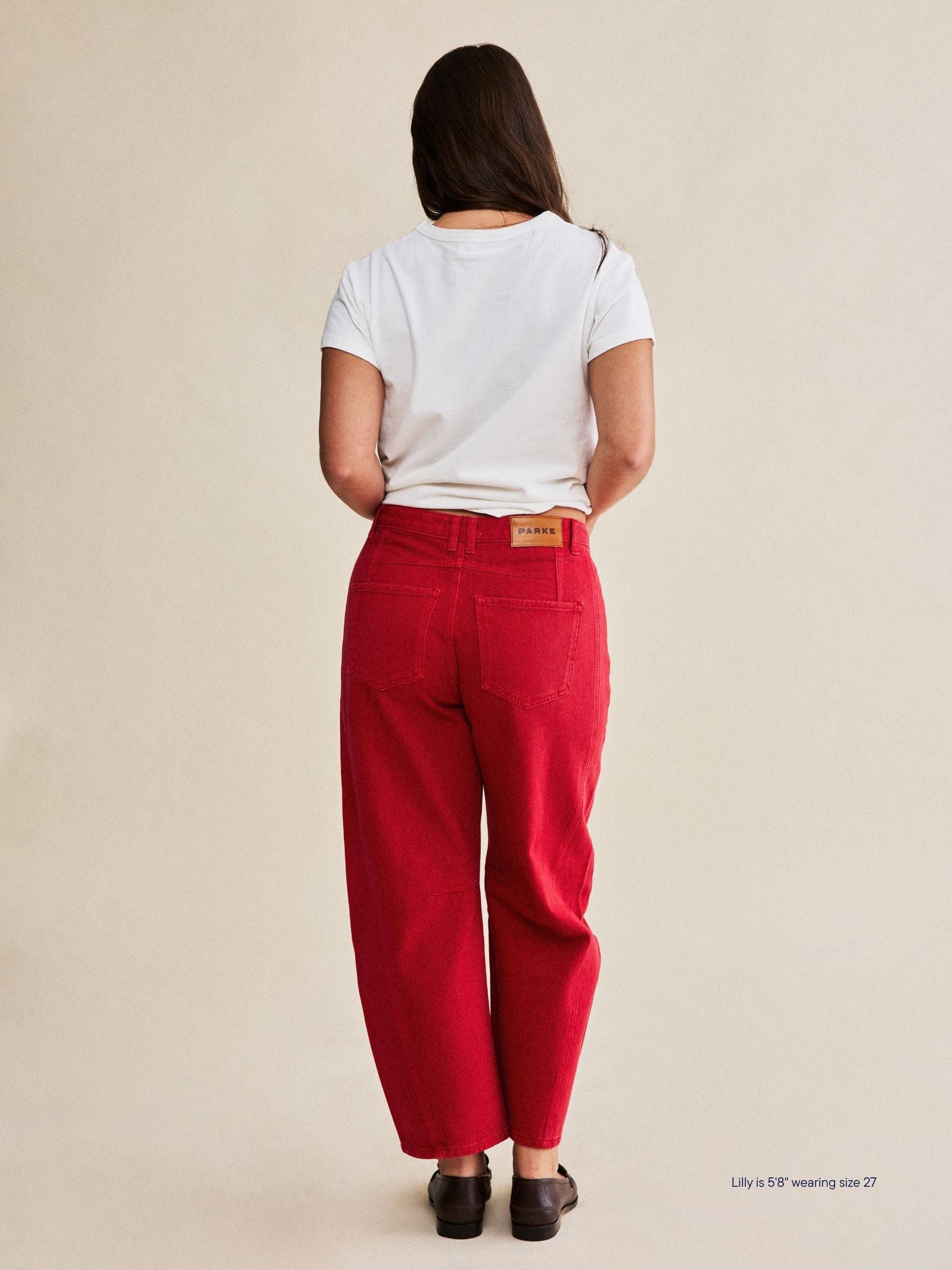 girl wearing horseshoe jeans -washed red