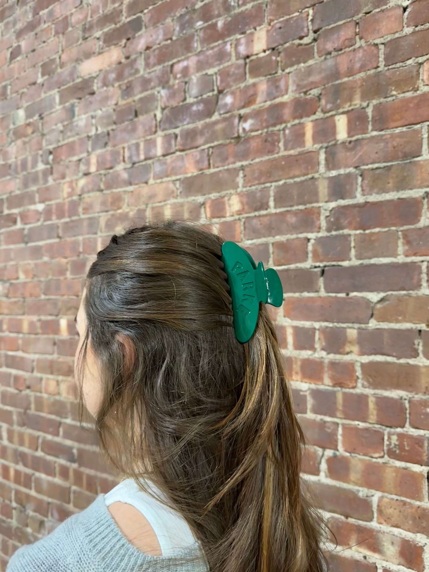 girl wearing green claw clip -green