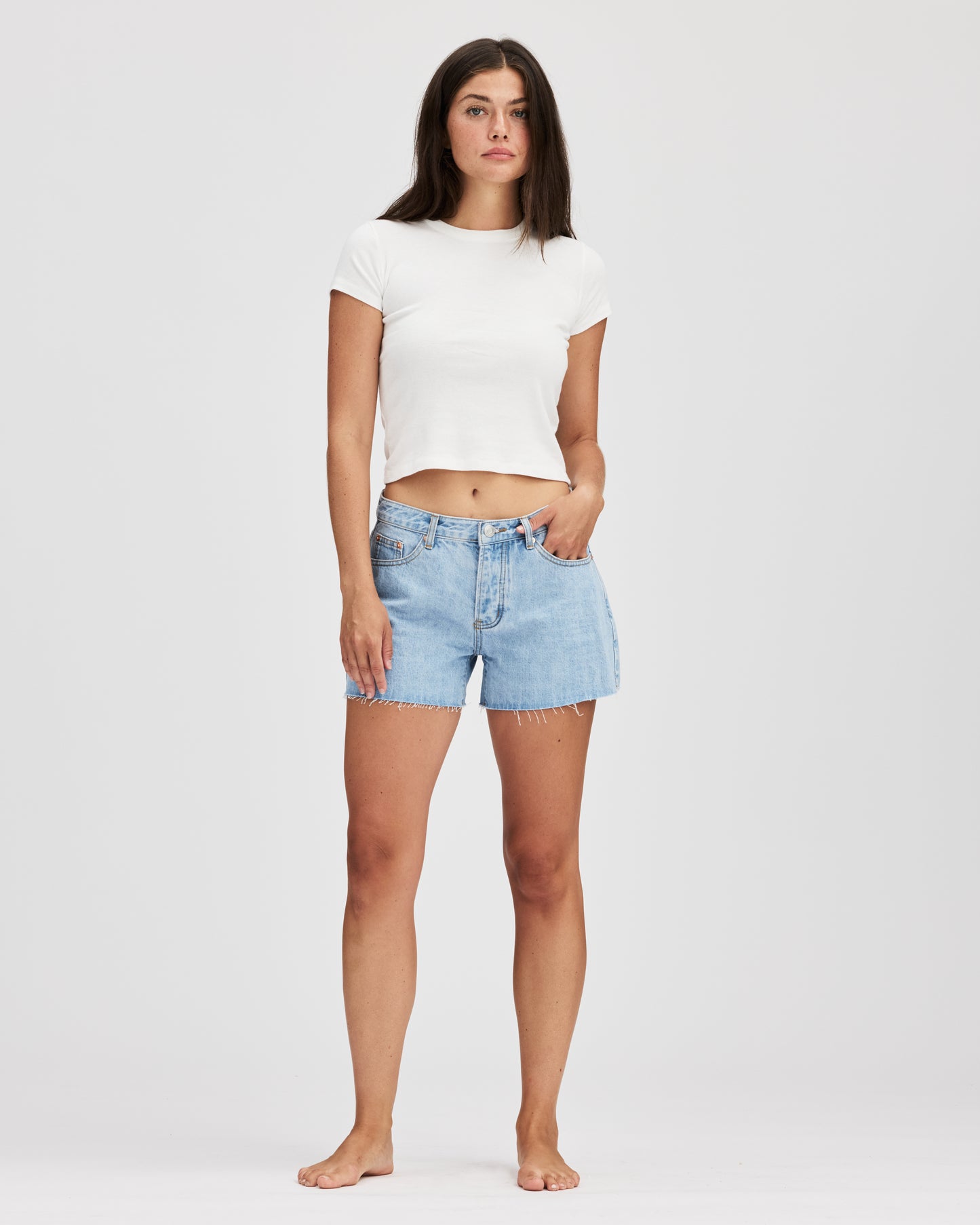 full body image of model wearing baggy shorts- light wash