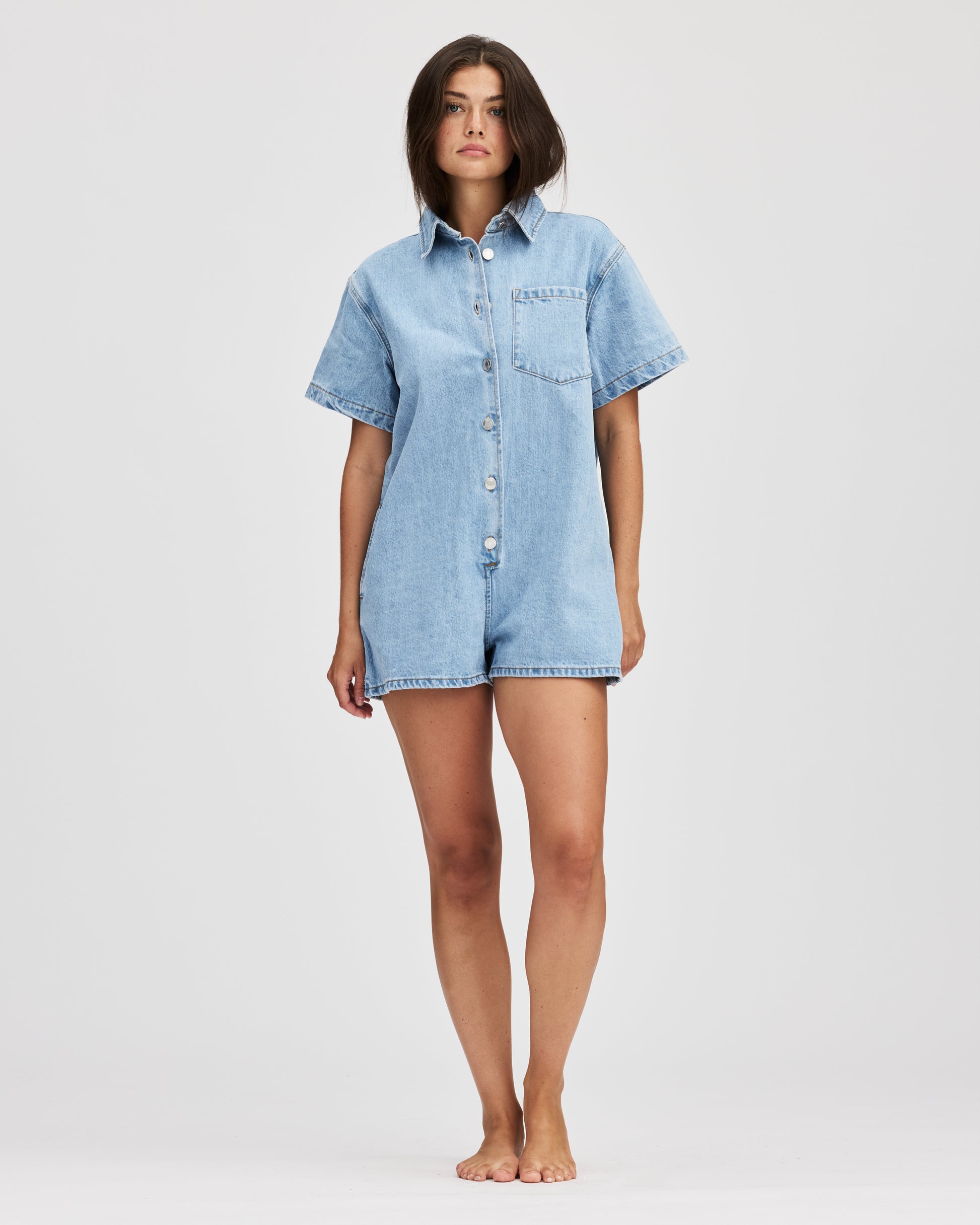 model wearing short sleeve denim romper - light wash