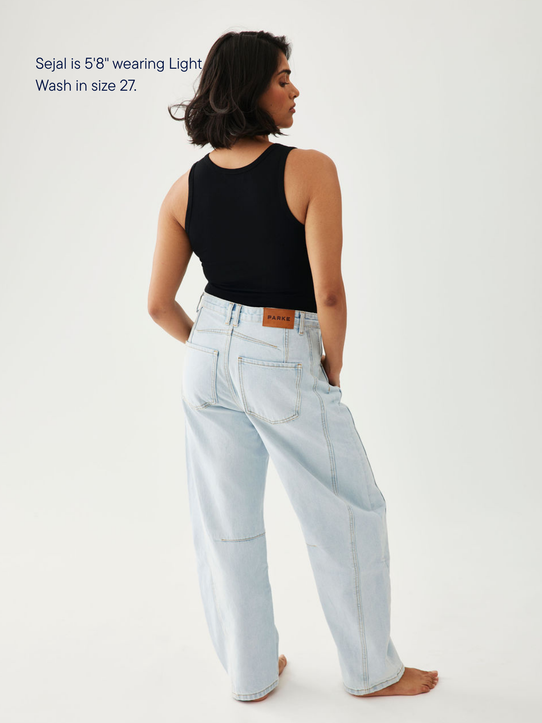 girl wearing horseshoe jeans -light wash