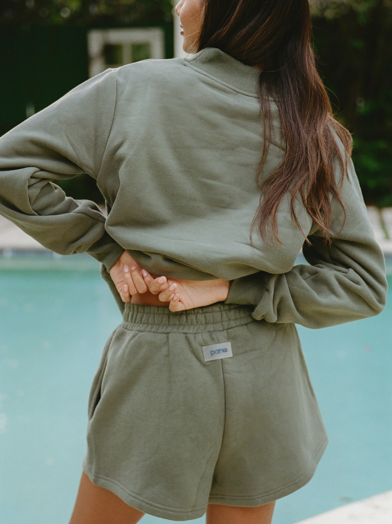 girl wearing hunter green sweatshort showing back patch detailing- hunter green