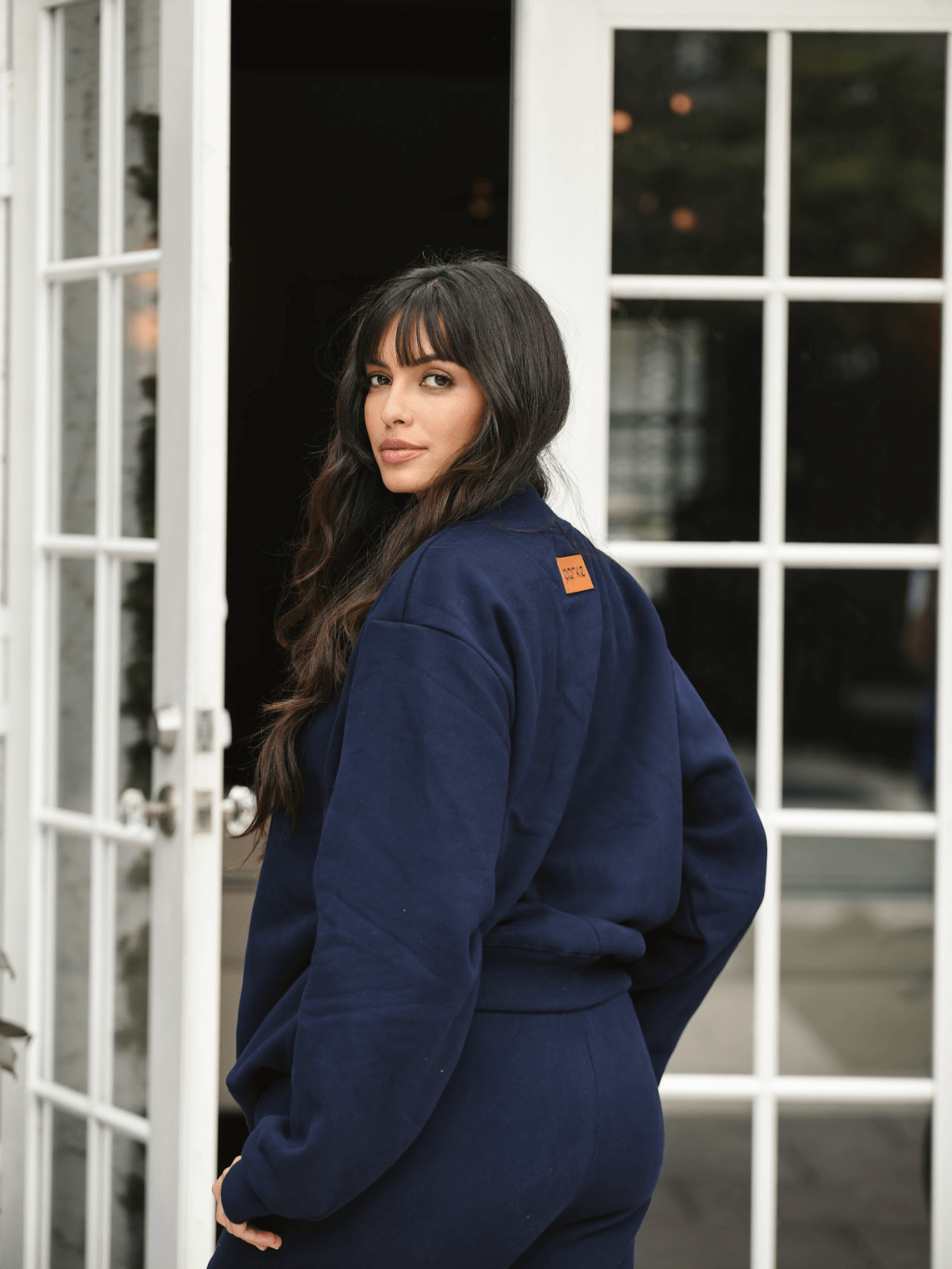 model wearing turtleneck sweatshirt showing back patch - navy