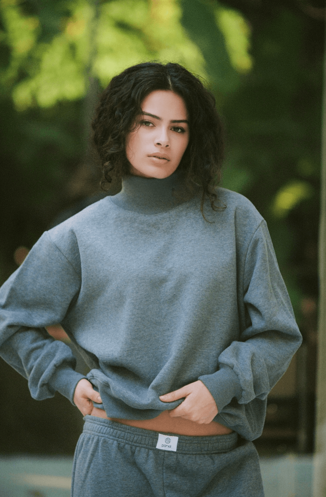 model wearing turtleneck sweatshirt - stormy