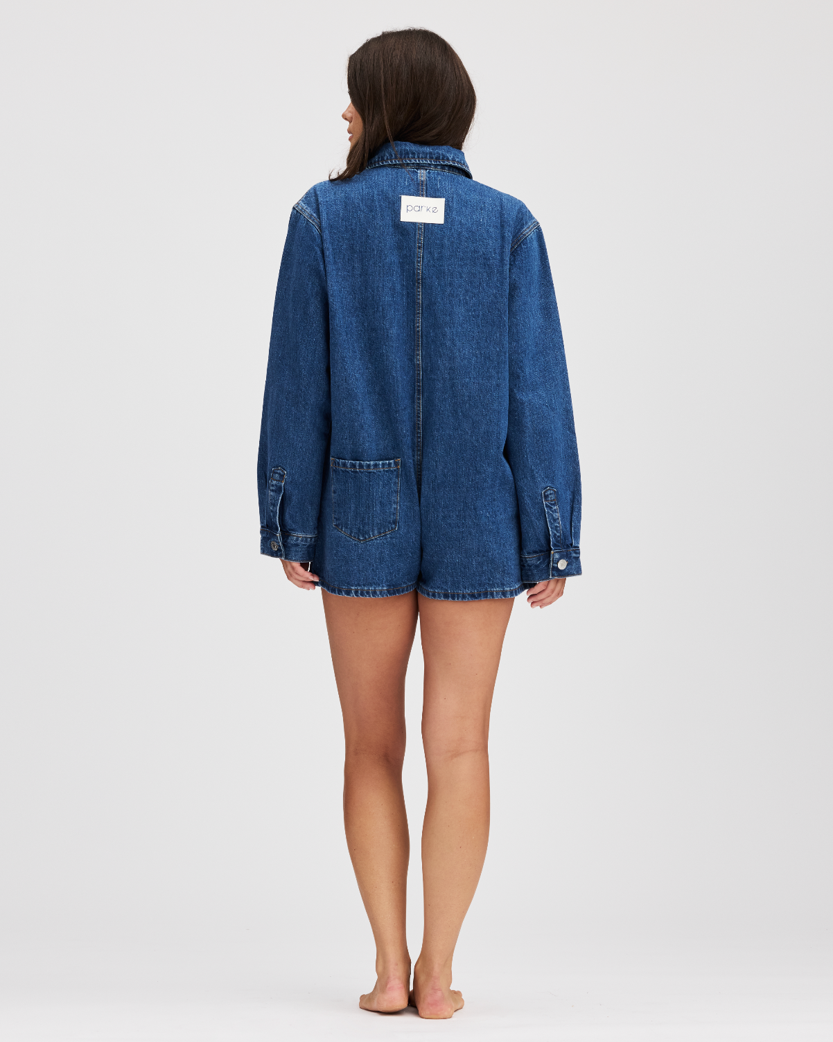 full body image of the back of the med wash long sleeve denim romper- med wash