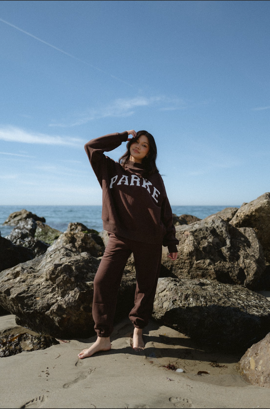 model wearing unisex sweats - chocolate brown + white