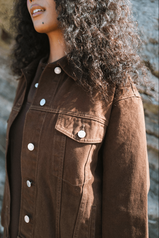 girl in chocolate brown oversized denim jacket showing front pocket and button - chocolate