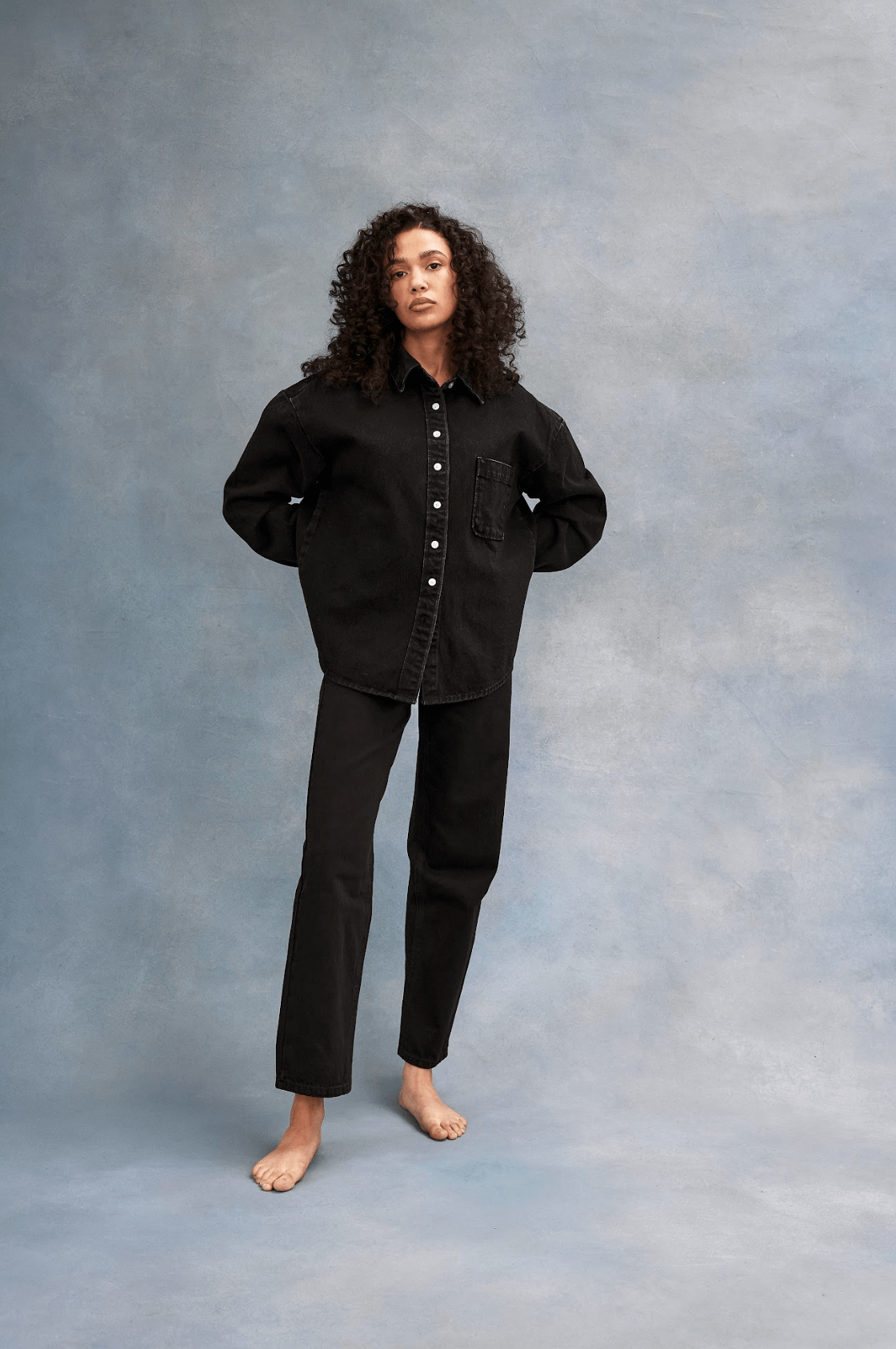 model wearing black classic straight jean and denim shirt - black